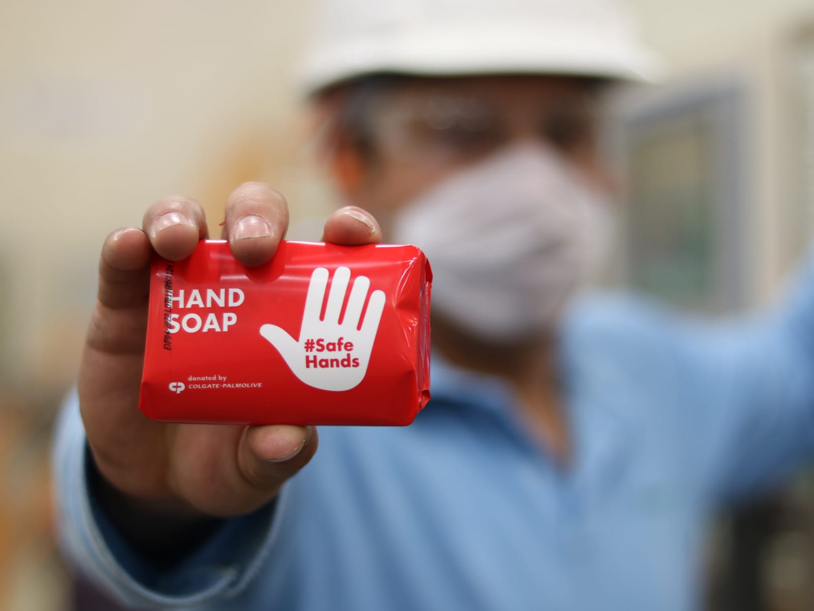 worker holds safe hands soap