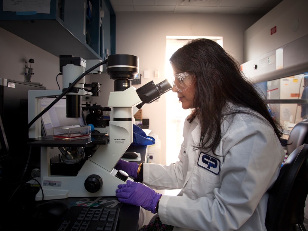 Colgate Palmolive scientist looking in the microscope