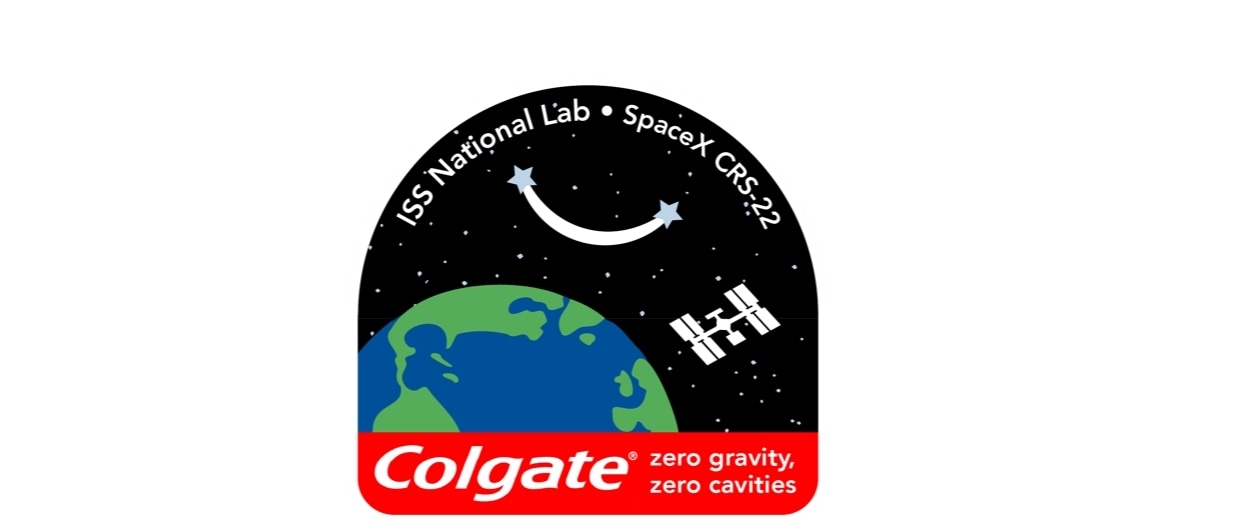 ISS National Lab logo with Colgate brand logo and zero gravity zero cavities tagline and SpaceX CRS-22