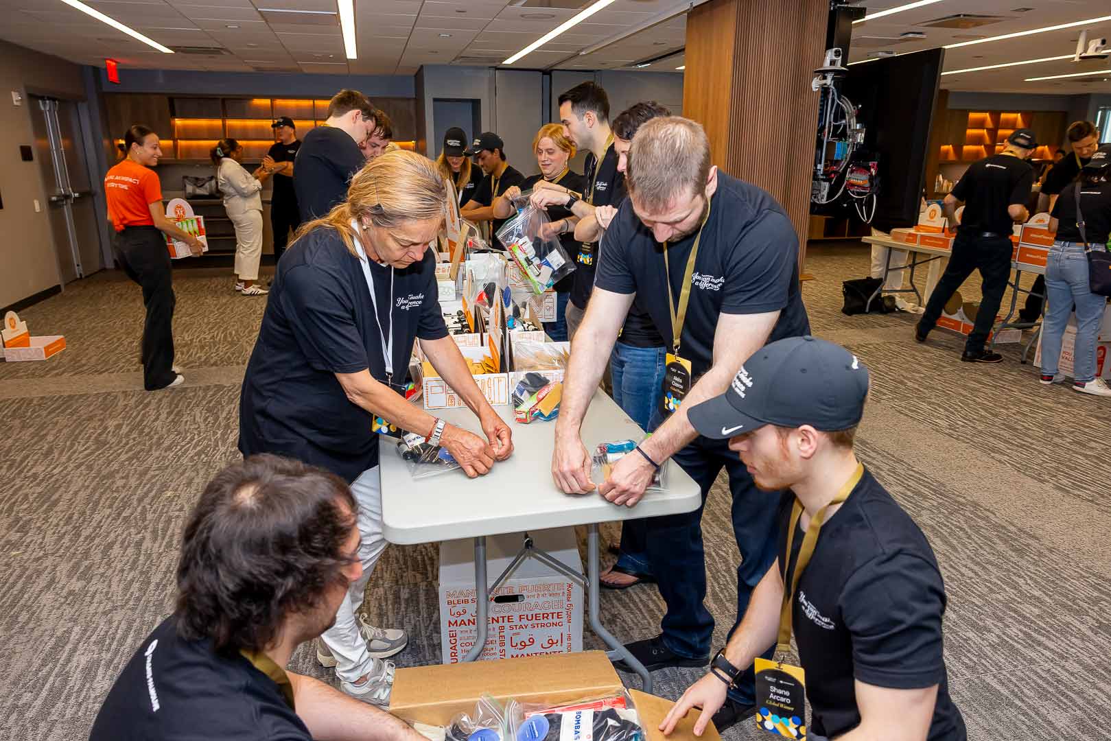 team working together to assemble essential health & hygiene kits
