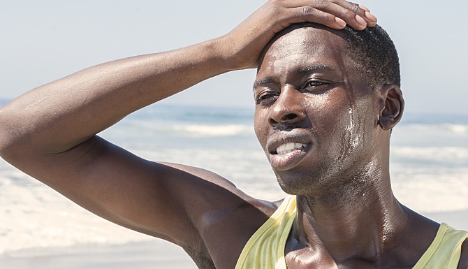 Man sweating a lot on the beach