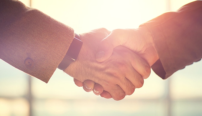 Business handshake. Business handshake and business people concept. Two men shaking hands over sunny