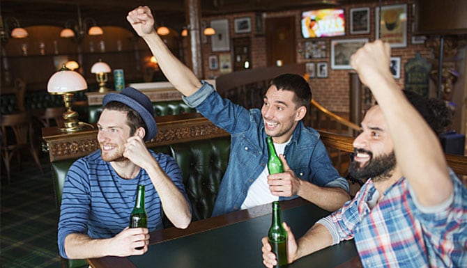 3 men drinking beer in a bar 3 men drinking beer in a bar