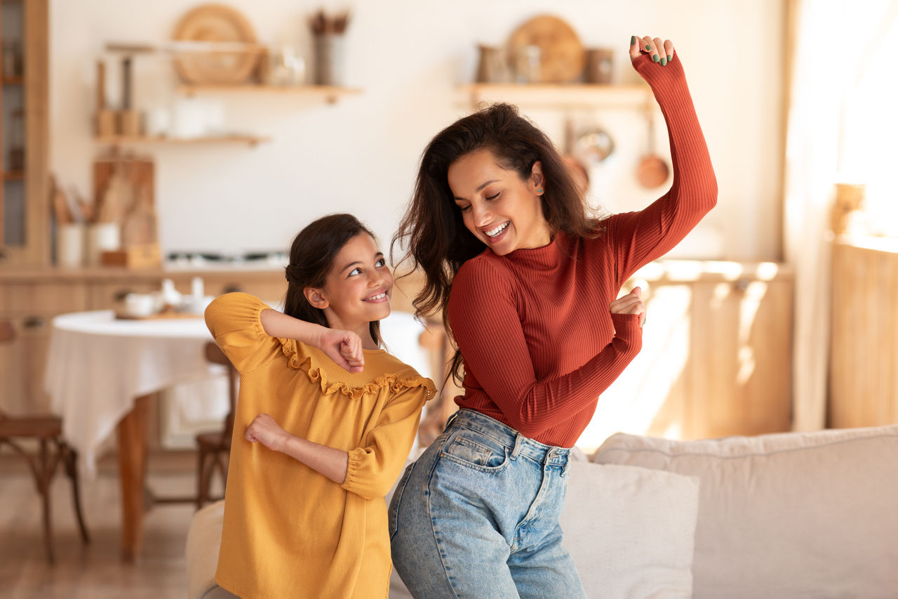 Mother and daughter dance together