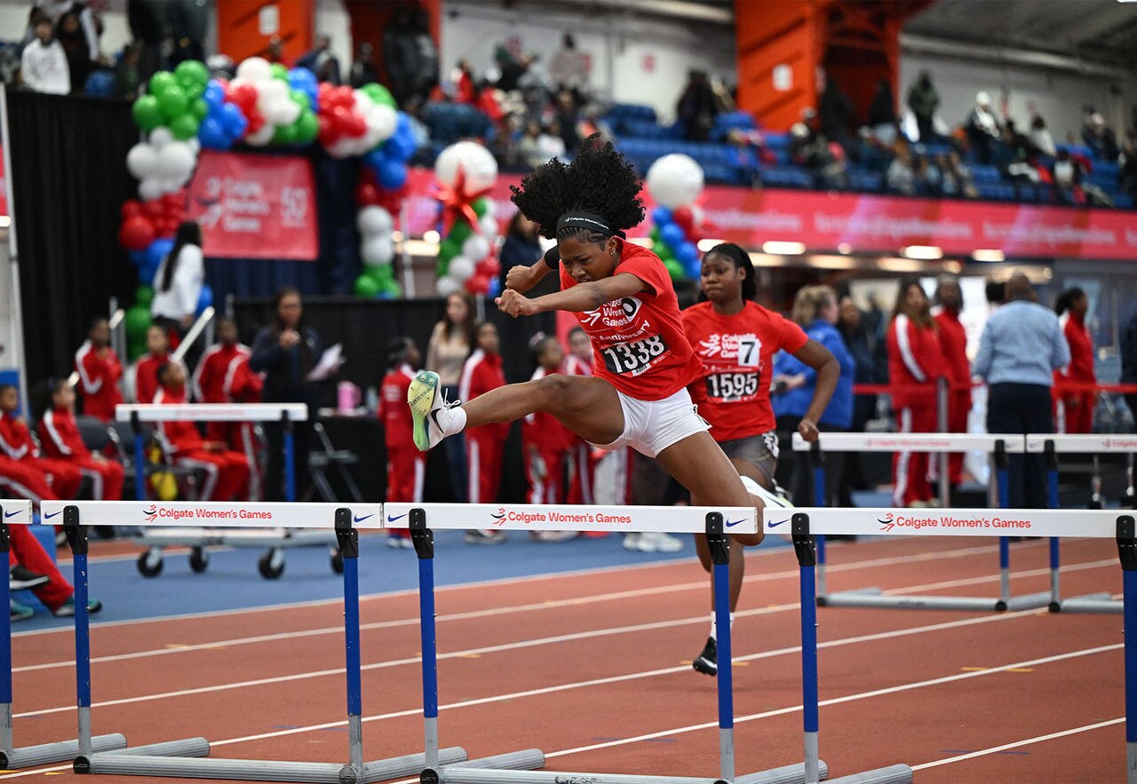 An athlete clears a hurdle during the 50th Anniversary Colgate Women's Games indoor track meet.