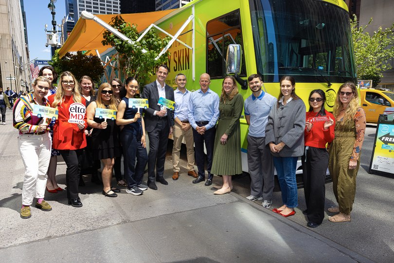 Colgate-Palmolive employees standing outside the Destination Healthy Skin mobile RV.