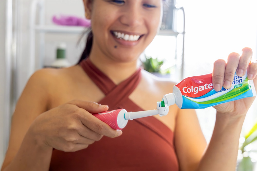woman with colgate toothpaste