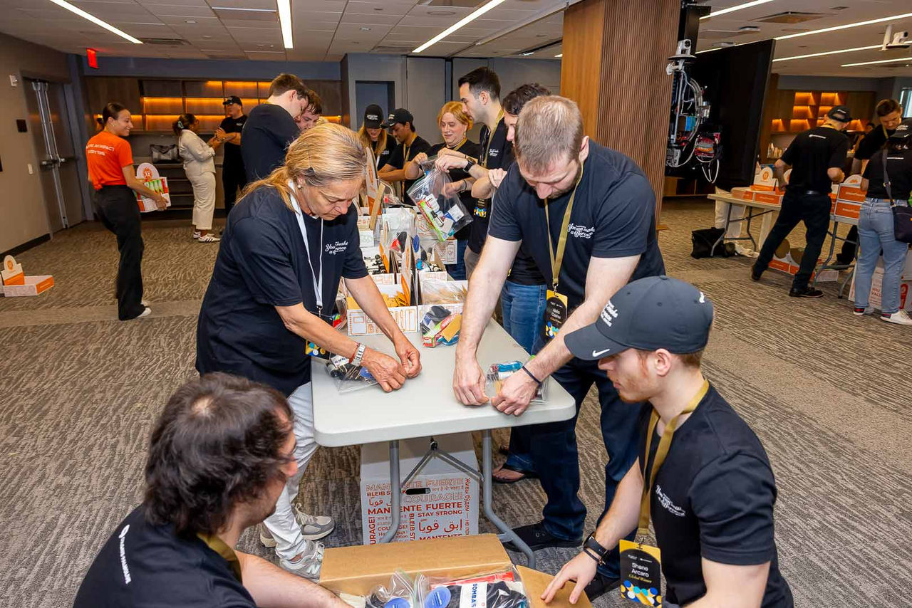 team working together to assemble essential health & hygiene kits